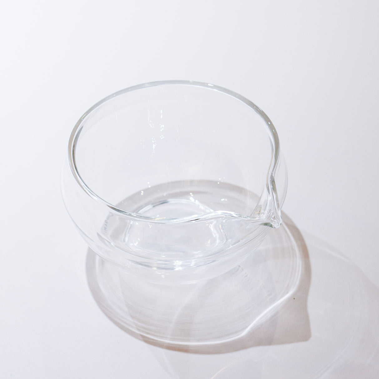 Clear glass pitcher on a white background